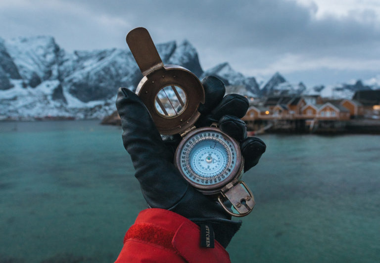 Guy with a compass seeking adventure