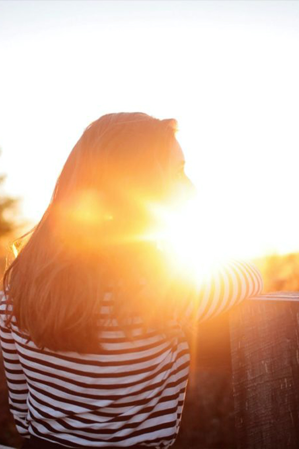 Girl looking out at the sunset