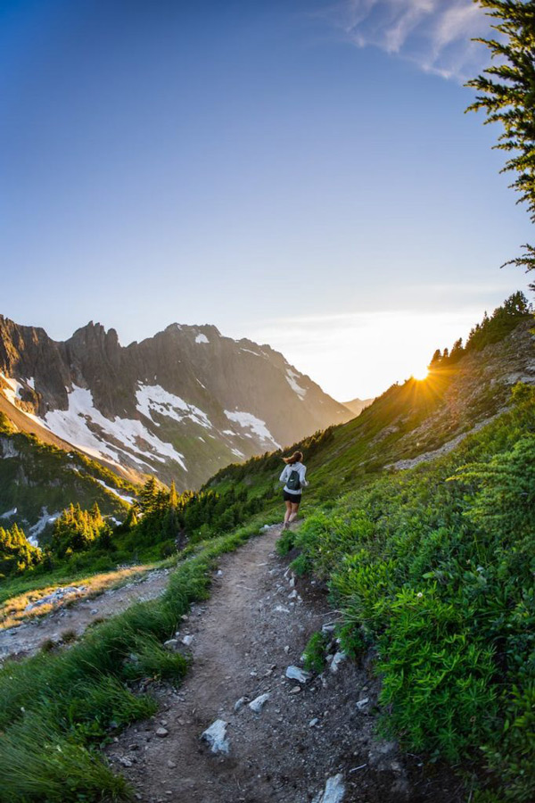 Girl trail running in the mountains